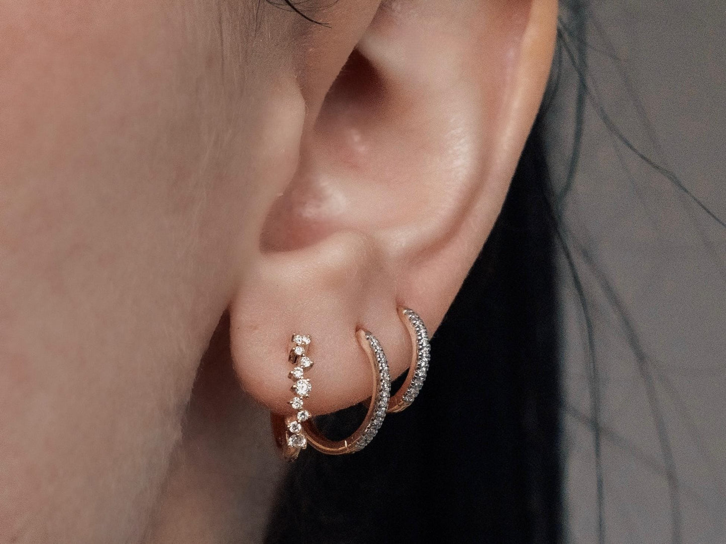 14k gold, scattered lab diamond hoop earrings being worn on ear, side view