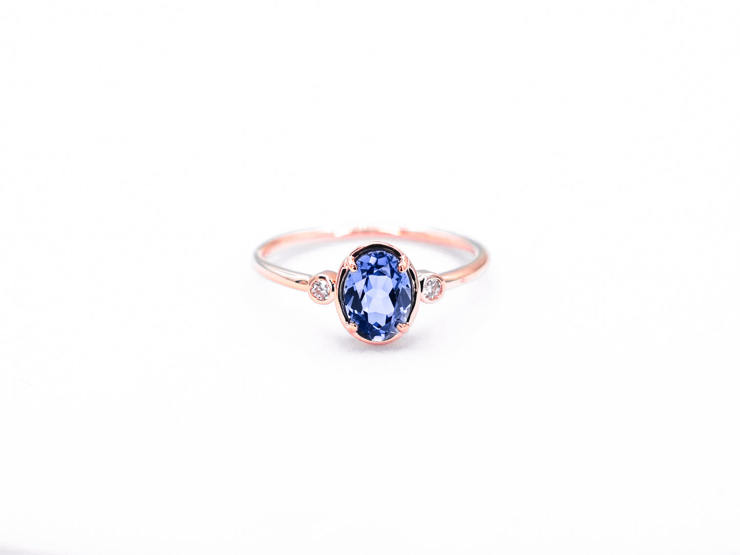 Bezel set oval sapphire diamond ring rose gold front view