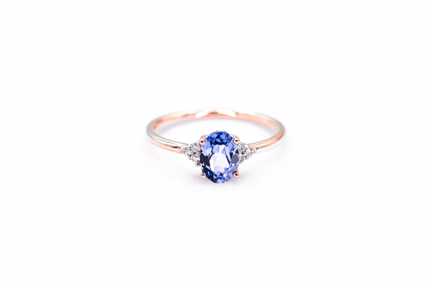 Oval sapphire rose gold ring with diamond accents front view