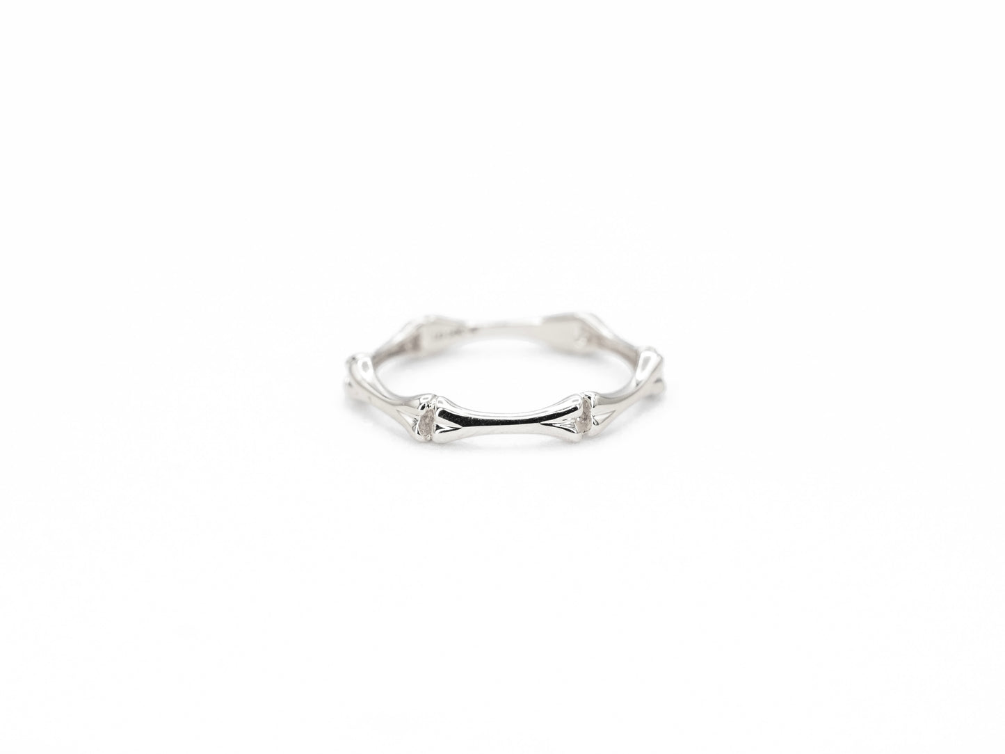 white gold bone shaped ring, front view