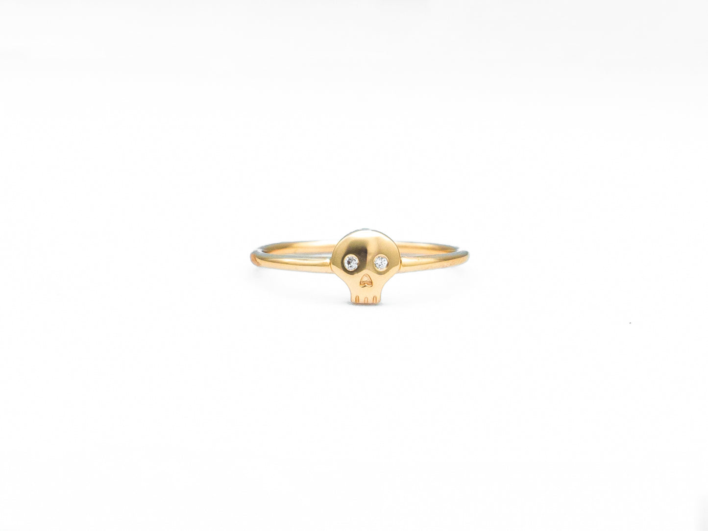 yellow gold diamond skull ring, front view