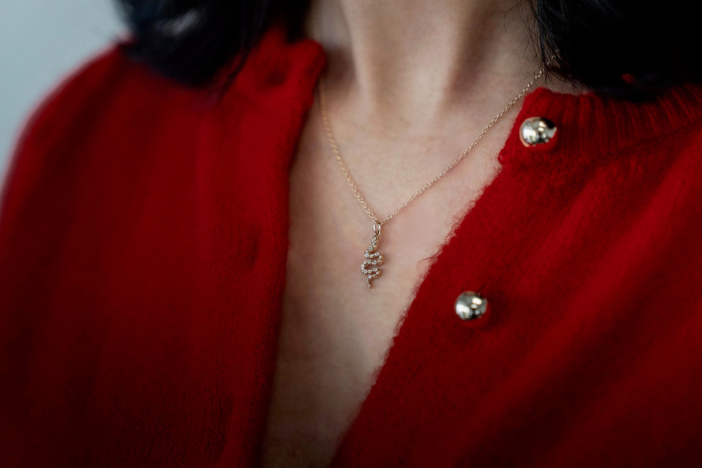 Solid yellow gold diamond snake pendant side view