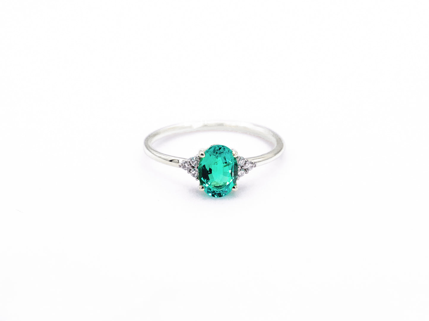 Oval sapphire white gold ring with diamond accents front view