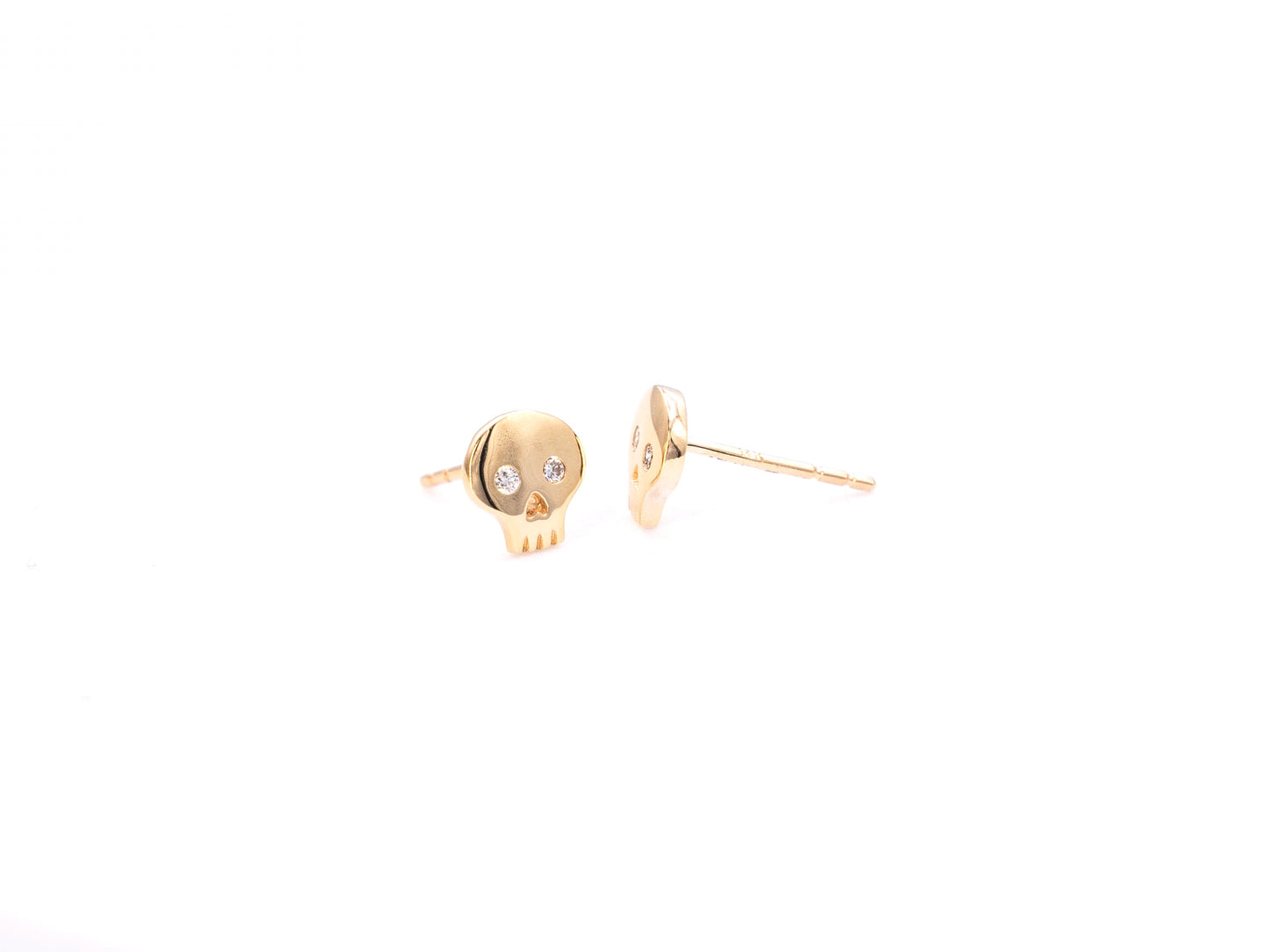 Yellow gold diamond skull stud earrings, front and side view