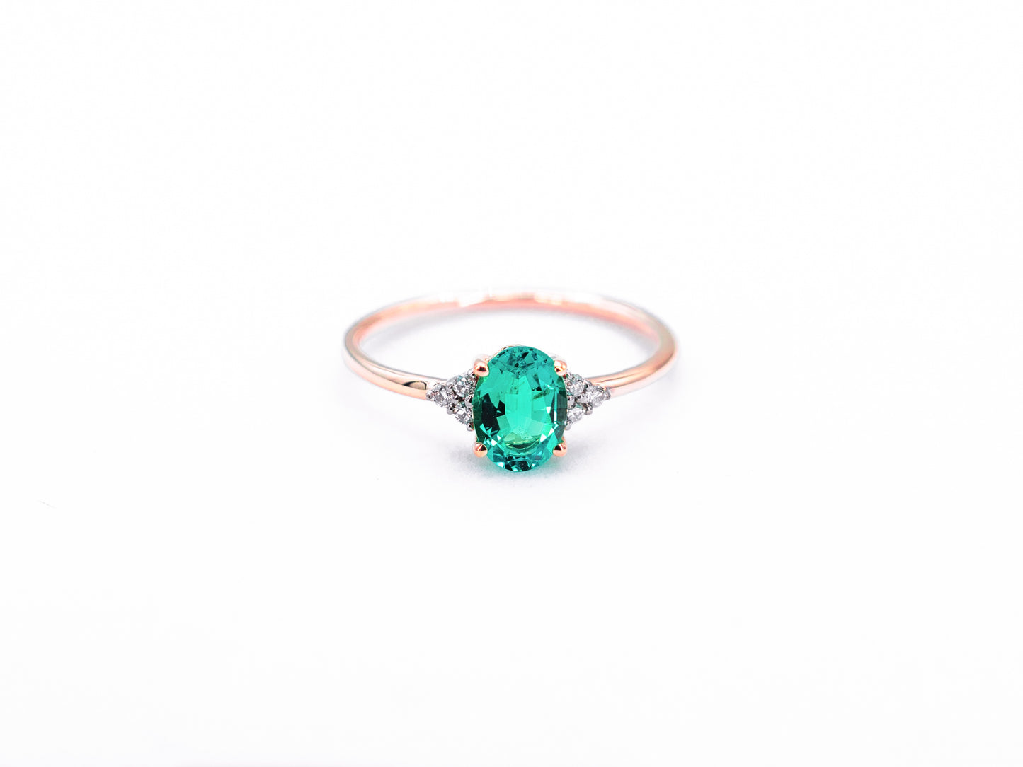 Oval sapphire rose gold ring with diamond accents front view