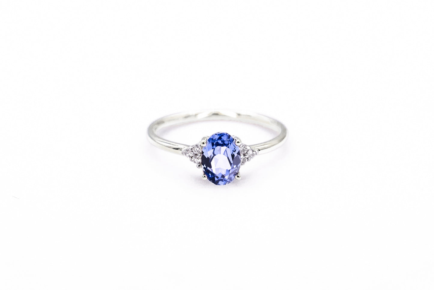 Oval sapphire white gold ring with diamond accents front view