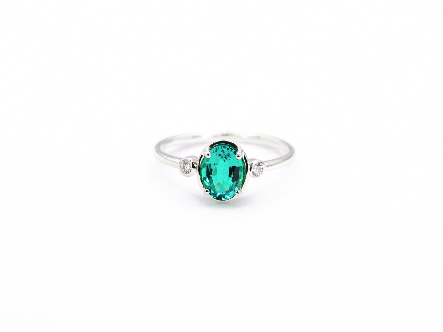 Bezel Inspired Oval Emerald and Diamond Ring