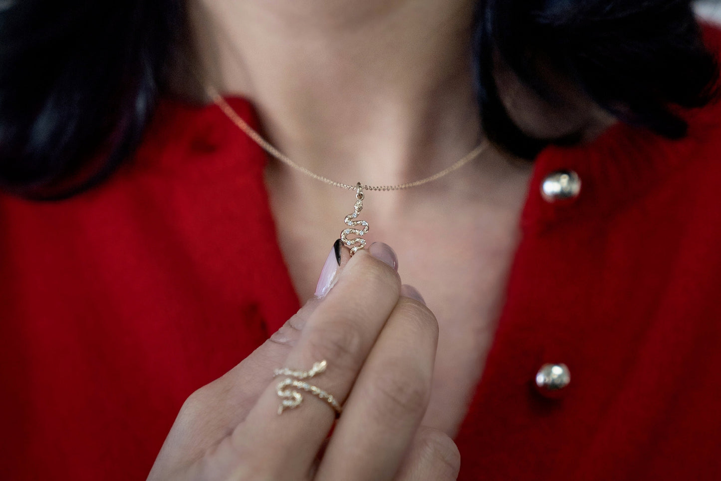 Solid yellow gold diamond snake pendant front view being worn