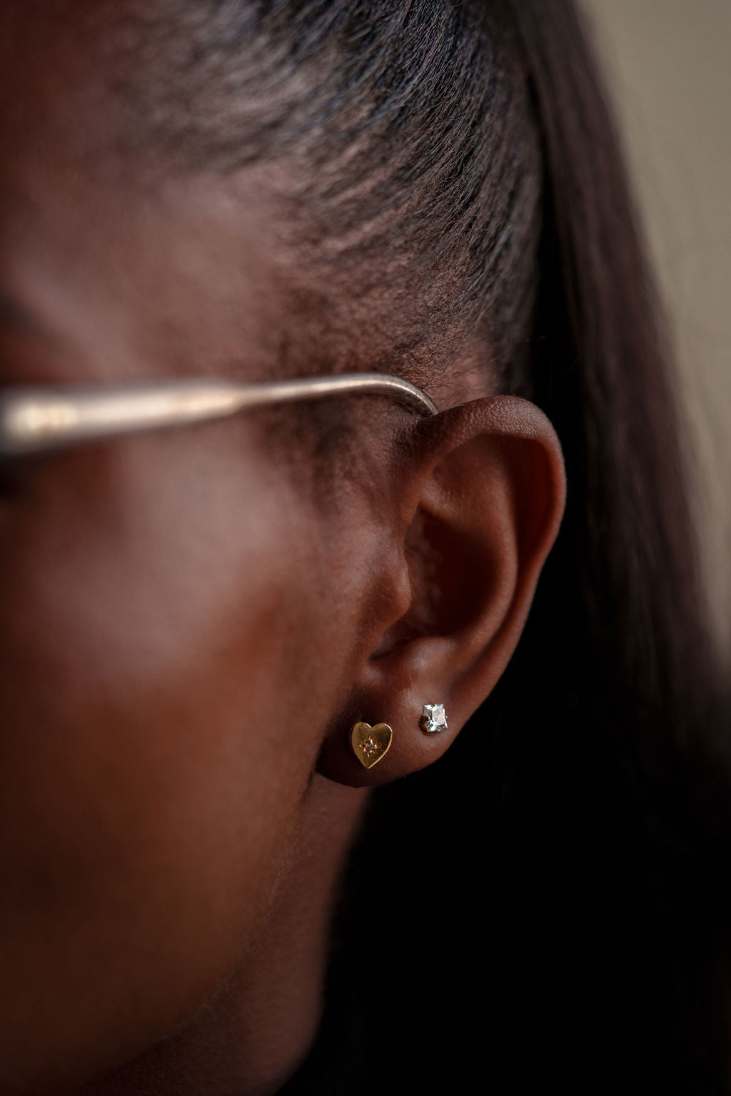 14k yellow gold, lab diamond, Northstar heart stud earrings worn on ear, side view