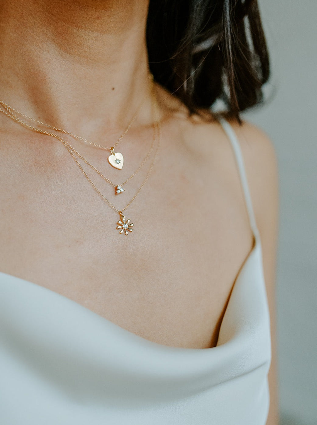 14k yellow gold, lab diamond daisy pendant worn on neck, side view