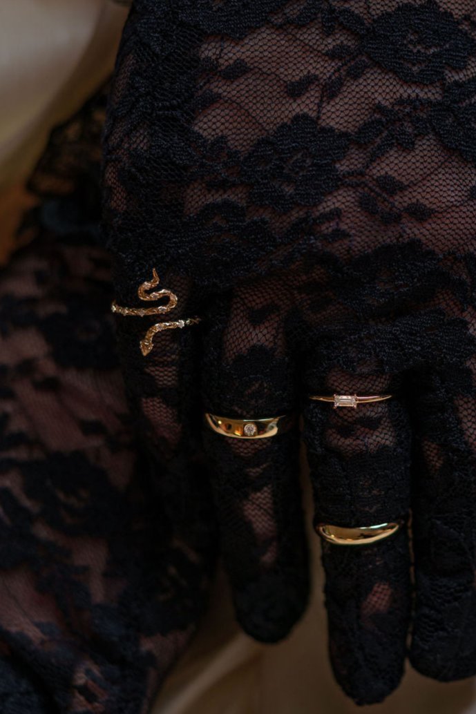 Snake shaped yellow gold diamond ring being worn on hand, top view