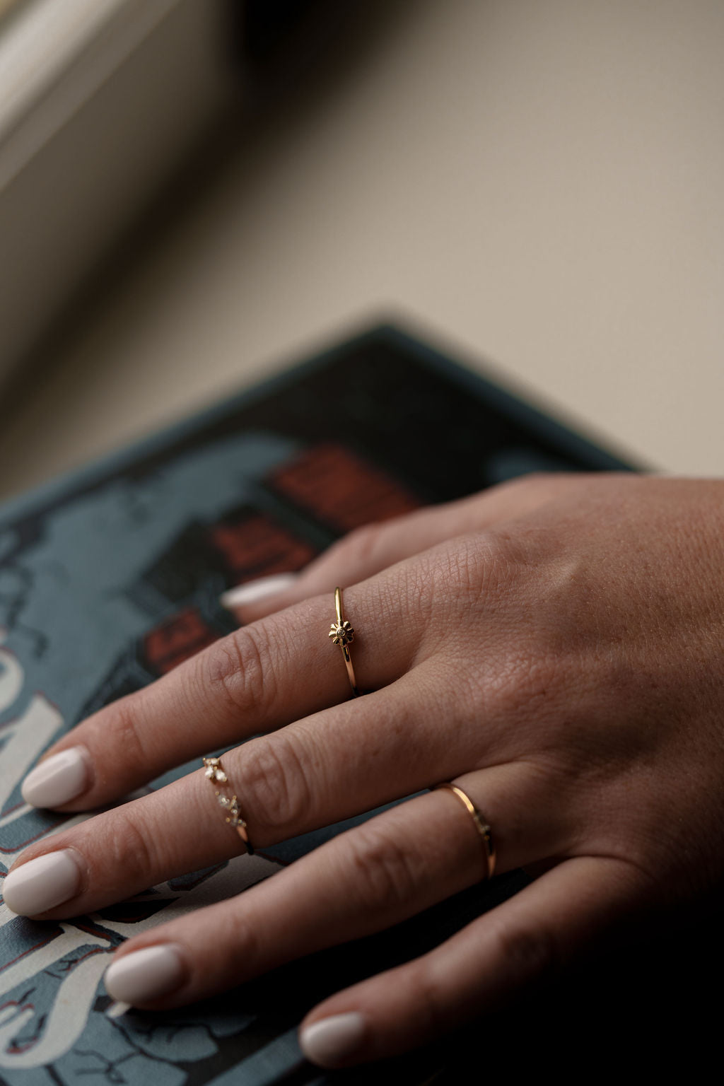 yellow gold, daisy diamond ring being worn on hand, top view
