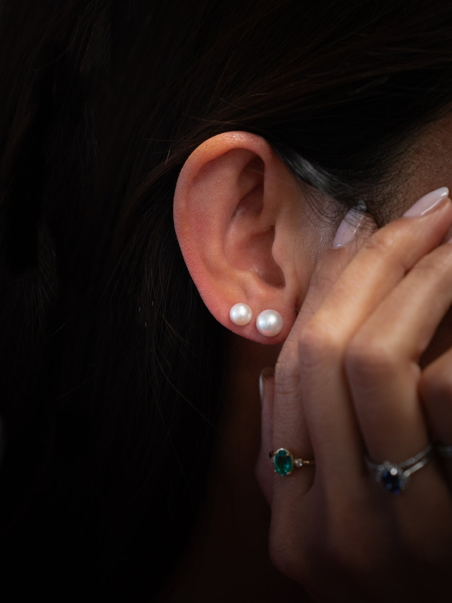 Freshwater stud earrings being worn on ear